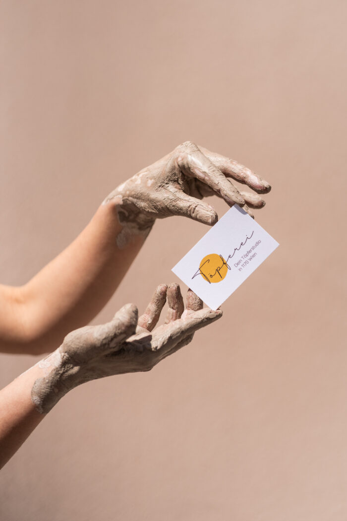 Muddy hands with card