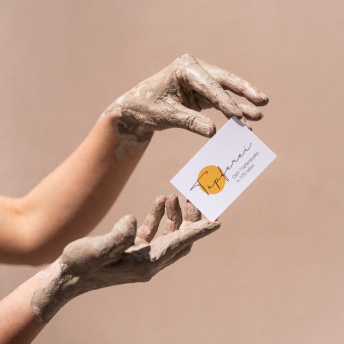 Muddy hands with card